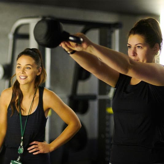 Two women at the gym managing anxiety