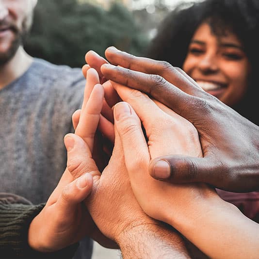 A group of people with their hands together