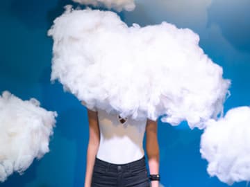 Woman with her head and shoulders hidden by a cloud