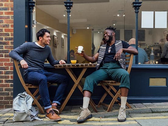 Two mean talking about their anxiety outside coffee shop