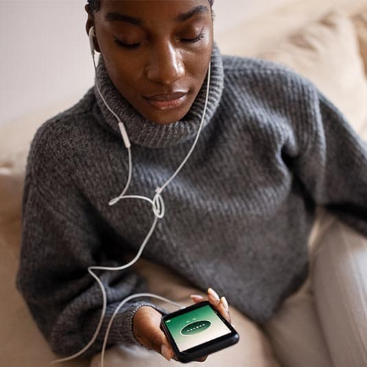Woman using a meditation app and managing anxiety
